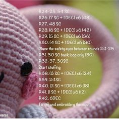 a pink crocheted teddy bear with numbers on it's face and back