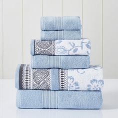 four blue towels stacked on top of each other