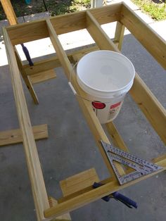 the bucket is sitting on top of the wooden frame and ready to be built into the floor