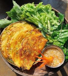 a basket filled with different types of food on top of a wooden table next to lettuce