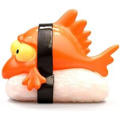 an orange and white plastic fish on top of a piece of food with a black strap