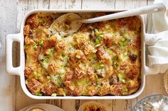 a casserole dish with meat and vegetables in it on a wooden table next to other dishes