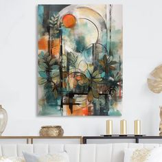 an abstract painting hangs on the wall above a white couch in a living room with gold accents