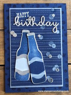 a blue birthday card with two beer bottles and the words happy birthday written on it