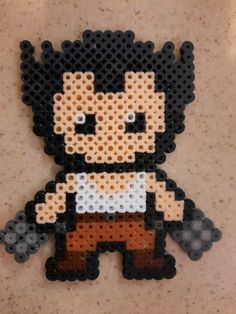 the pixel art is made out of black and white plastic beads, with an image of a