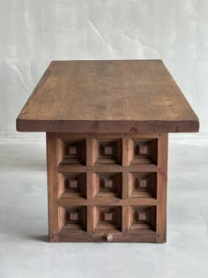 a wooden table with several compartments in it