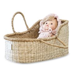 a baby doll in a wicker bassinet