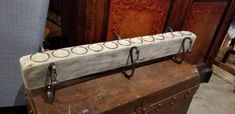 an old trunk with some white plates on it and two metal hooks hanging from the handle