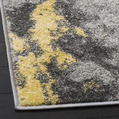 an area rug with yellow and gray colors