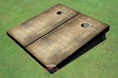 an image of two large wooden boards on the ground with holes cut out to make them look like they have been made from wood