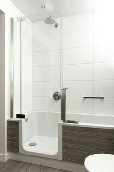 a bathroom with a shower, toilet and sink in it's corner area is shown