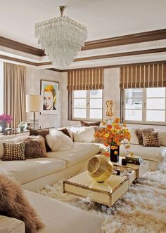 a living room filled with lots of white furniture