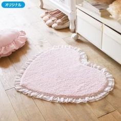 a heart shaped rug is on the floor next to a child's crib