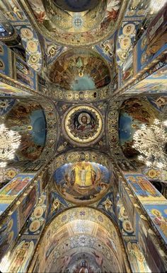 the inside of a church with many paintings on it's walls and ceilinging