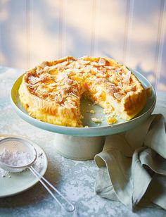 a pie sitting on top of a table next to a plate with a slice missing