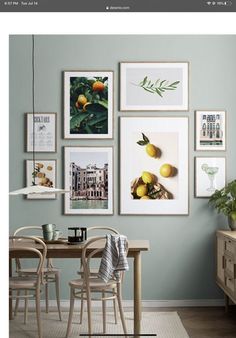 a dining room table with chairs and pictures on the wall above it, along with other furniture