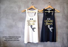 two women's tank tops hanging up against a wall with the words mermaid and bride written on them