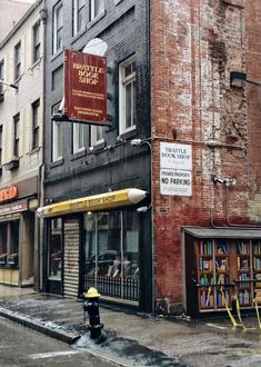 a fire hydrant in front of a book store on the side of a street