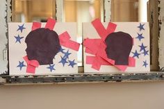 two pieces of paper cut out to look like people's heads with red, white and blue stars on them