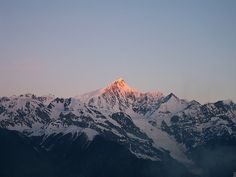 the top of a mountain with snow on it