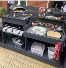 an outdoor bbq grill with lots of food on it