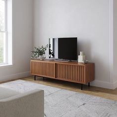 a flat screen tv sitting on top of a wooden cabinet