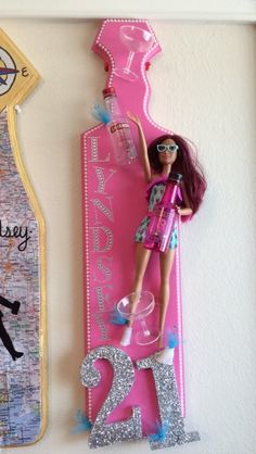 a barbie doll is posed next to a pink sign with the number twenty two on it