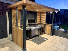 an outdoor kitchen with a grill and sink