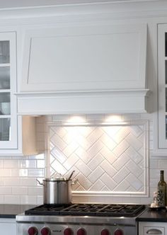 a stove top oven sitting inside of a kitchen next to a wall mounted range hood