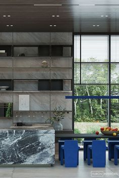 a modern kitchen with marble counter tops and blue chairs