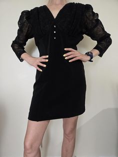 This is a super lovely Goth punk mini 1980s Puff sleeve mini  Dress for the retro fan. Features awesome lace on both sleeves and nice button detailing. Great for any occasion...perhaps a funeral, a party or costume as Beetlejuice's girl. Dress has stretch on bodice. In excellent vintage condition. Made in Canada. Polyester material. Size S/M. Measurements (taken with dress laying flat on the ground): 34" long 14.5" waist 17.5" pit to pit 15" hips Beetlejuice Girl, Retro Fan, Goth Punk, Beetlejuice, Mini Dress With Sleeves, Black Mini, Dress Clothes For Women, Fashion Inspiration, Puff Sleeve