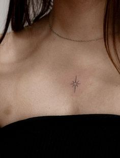 a woman's chest with a small star tattoo on her left side ribcage