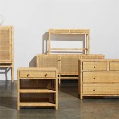 four pieces of furniture made out of wood and rattan, with one drawer open