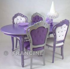 a purple and white dining table with chairs