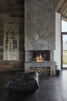 a stone fireplace in the middle of a room