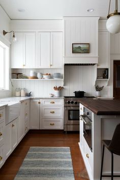 the kitchen is clean and ready for us to use it's white cabinetry