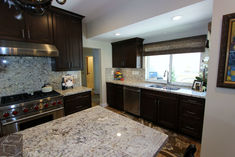 a kitchen with granite counter tops and stainless steel appliances