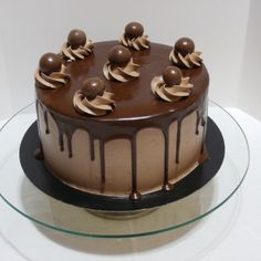 a chocolate cake with icing and chocolate decorations