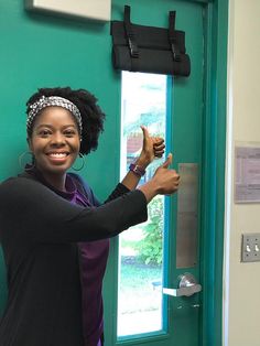 a woman standing in front of a green door