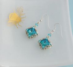 These beautiful vintage style earrings are hand stitched from Austrian crystals in a stunning lagoon blue colour, which is turquoise with a background of green. I finished the design with tiny Japanese seed beads to form these lovely diamond shaped earrings. They are really sparkly with lovely depth of colour in the crystals. They would look beautiful for an evening out or would be great as bridesmaid earrings. The stone is 12mm in size and the earrings measure approx 2.5cm long (around 1inch) The earwires are sterling silver. For more of my vintage style earrings, why not take a look here: https://www.etsy.com/uk/shop/Turquoisebee?ref=l2-shopheader-name&search_query=vintage+style+earrings Thank you Handmade Turquoise Crystal Earrings, Handmade Blue Aquamarine Earrings, Handmade Turquoise Aquamarine Earrings, Seafoam Color, Diamond Shape Earrings, Stone Dangle Earrings, Vintage Style Earrings, Bead Work Jewelry, Beaded Drop Earrings