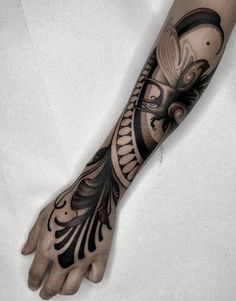 a person's arm with a tattoo on it and a clock in the middle