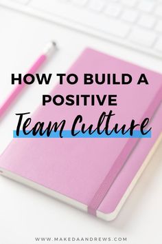 a pink notebook with the words how to build a positive team culture on top of it