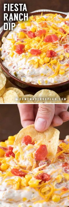 a person holding a tortilla chip in front of a plate with corn and salsa dip