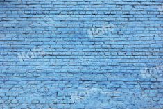 a blue brick wall with graffiti on it