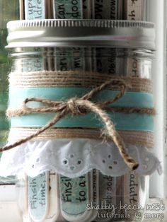 a jar filled with lots of different types of tape and twine on top of a window sill