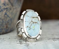 "Handcrafted Sand Hill Turquoise Sterling Silver Statement Ring. This chunky ring has been handmade using 925 Sterling Silver that has been fused, stamped and oxidized. The setting is an oval 22mm x 12mm Sand Hill Turquoise Cabochon that is in a Bezel setting accented with stamped wire. At its widest the band is 1/2\" then narrows to 1/8\" for a comfortable fit. This ring cannot be resized. Size 5 Introducing our Sand Hill Turquoise Silver Statement Ring! This exquisite handcrafted piece is boun Heirloom Oval Turquoise Cabochon Ring, Elegant Oval Turquoise Ring With Large Stone, Turquoise Oval Cabochon Ring With Polished Finish, Southwestern Style Turquoise Oval Ring With Polished Finish, Southwestern Style Oval Turquoise Ring With Polished Finish, Oval Turquoise Ring With Polished Finish, Southwestern Oval Cabochon Gemstone Ring, Oval Turquoise Ring With Polished Finish As Gift, Southwestern Style Oval Cabochon Gemstone Ring