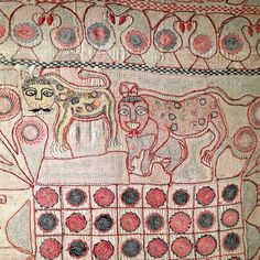 an embroidered cloth with animals and circles on it