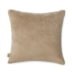 a beige pillow with a square shape on the front and back, made out of sheep fur