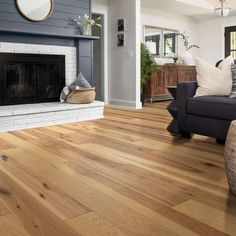 a living room filled with furniture and a fire place in the middle of the room