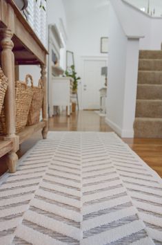 a white rug on the floor in front of stairs